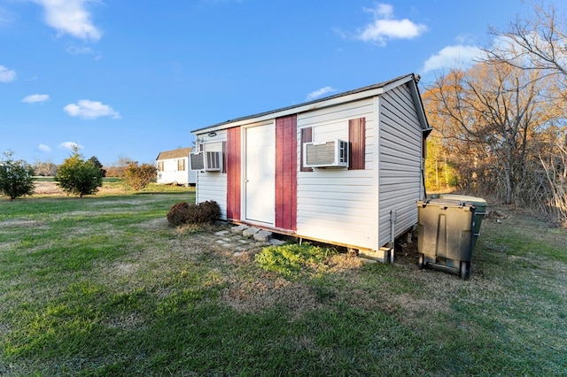 view of outdoor structure featuring cooling unit and a lawn