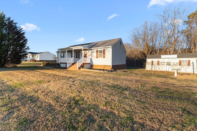 ranch-style home with a porch and a front yard