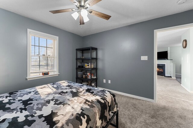 bedroom with carpet flooring, ceiling fan, and a textured ceiling