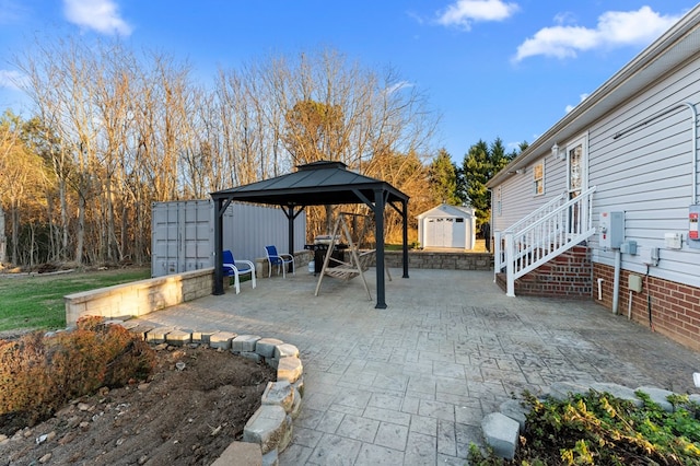 view of patio / terrace with a gazebo, a grill, and an outdoor structure