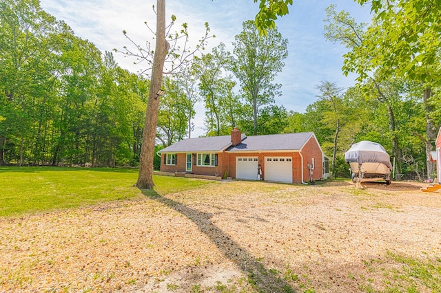 62 Denver Rd, Heathsville, VA 22473 - view of front of home with a chimney, a garage, a front yard, and brick siding