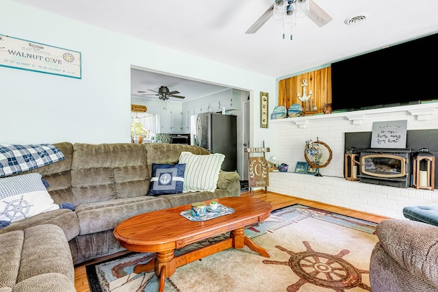 62 Denver Rd, Heathsville, VA 22473 - living area with ceiling fan, a wood stove, and light wood-type flooring