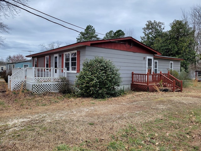 view of side of property with a wooden deck