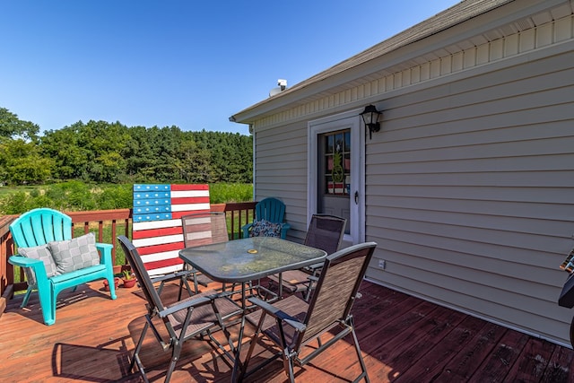 wooden deck featuring outdoor dining space