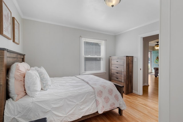 bedroom featuring ornamental molding and wood finished floors