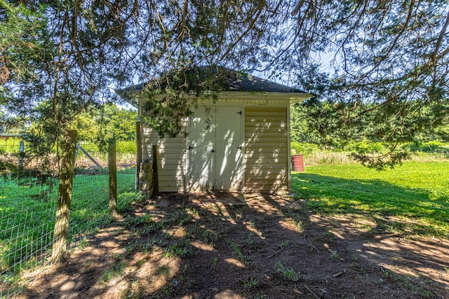 view of shed featuring fence