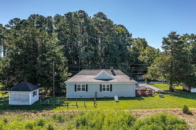 back of house featuring a yard, crawl space, fence, an outdoor structure, and a wooden deck