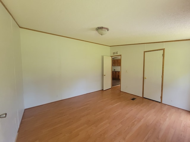 159 Dirt Bridge Rd, Topping, VA 23169 - unfurnished bedroom featuring light wood-style flooring and crown molding