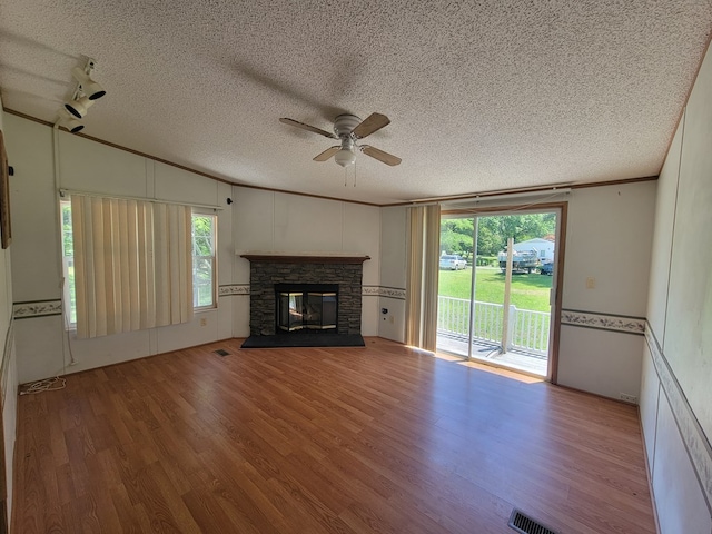 159 Dirt Bridge Rd, Topping, VA 23169 - unfurnished living room with ceiling fan, wood finished floors, a textured ceiling, ornamental molding, and a stone fireplace