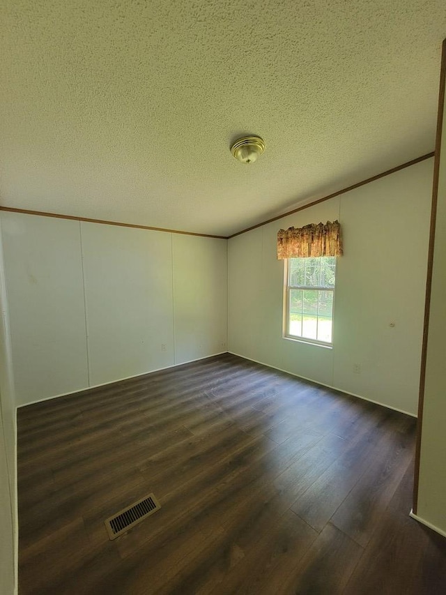 159 Dirt Bridge Rd, Topping, VA 23169 - unfurnished room with dark wood finished floors, a textured ceiling, and crown molding