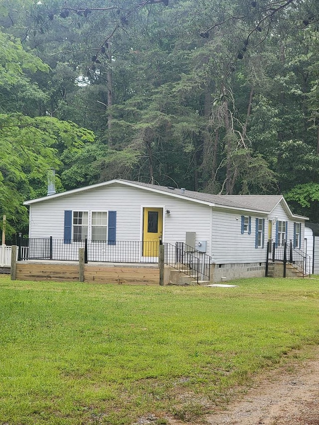 159 Dirt Bridge Rd, Topping, VA 23169 - view of front facade with crawl space, a front yard, and a view of trees