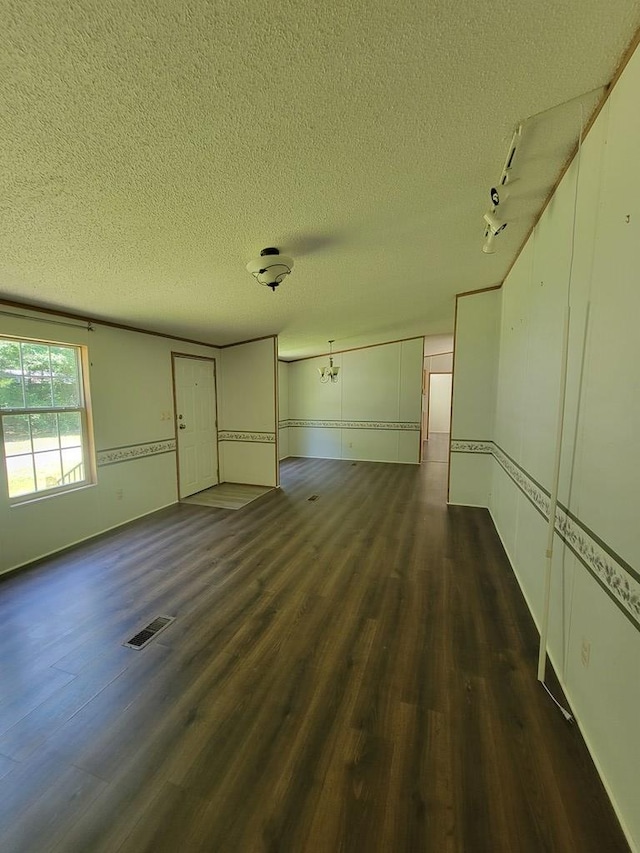 159 Dirt Bridge Rd, Topping, VA 23169 - unfurnished room with dark wood-type flooring, a textured ceiling, and baseboards