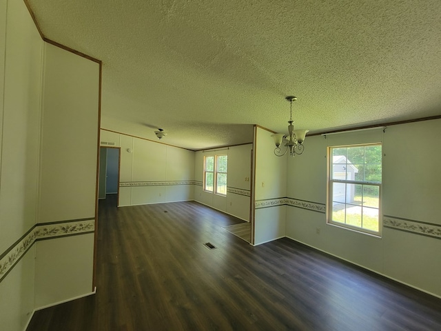159 Dirt Bridge Rd, Topping, VA 23169 - unfurnished room featuring a chandelier, dark wood-style flooring, and a textured ceiling