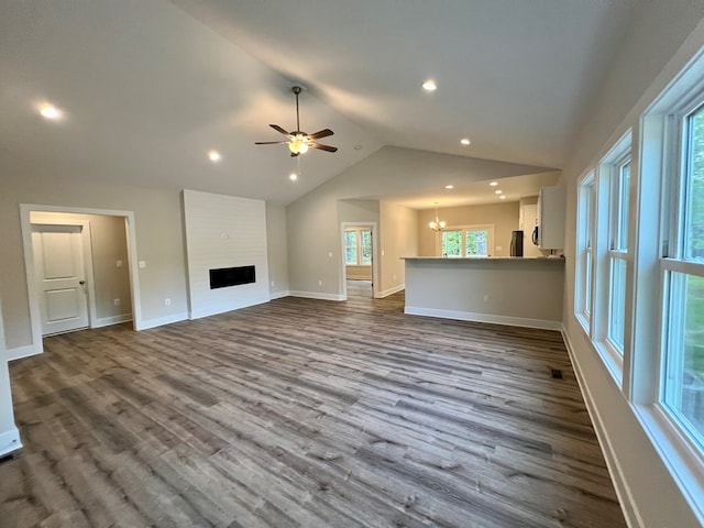 366 N Glebe Rd, Montross, VA 22520 - unfurnished living room featuring vaulted ceiling, dark wood-style flooring, a ceiling fan, recessed lighting, and a chandelier
