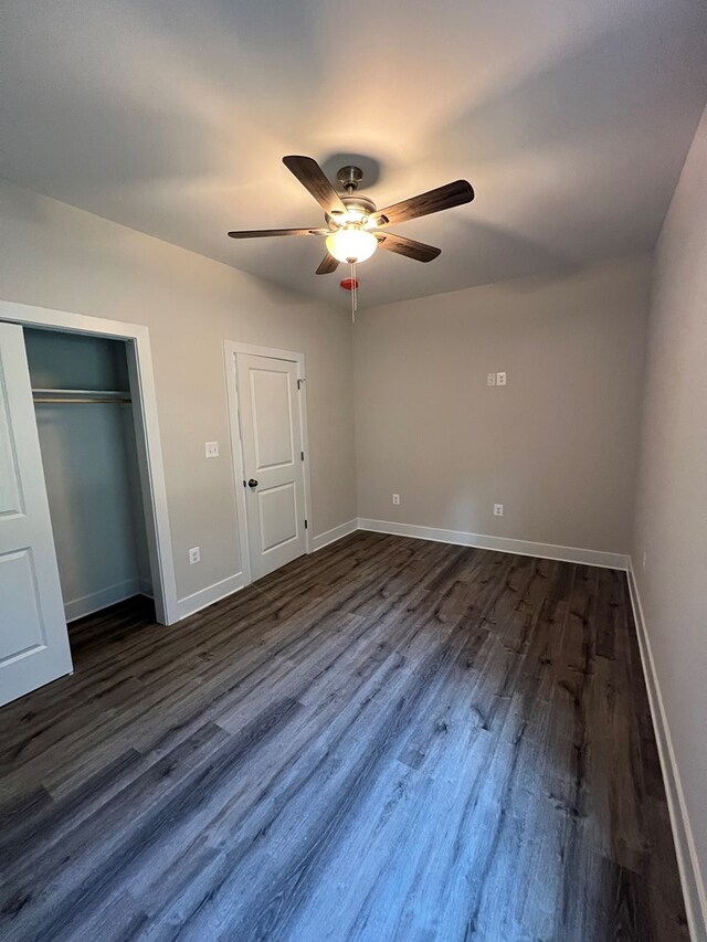 366 N Glebe Rd, Montross, VA 22520 - unfurnished bedroom featuring dark wood finished floors, baseboards, a closet, and ceiling fan