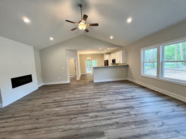 366 N Glebe Rd, Montross, VA 22520 - unfurnished living room with dark wood finished floors, lofted ceiling, a fireplace, a chandelier, and baseboards