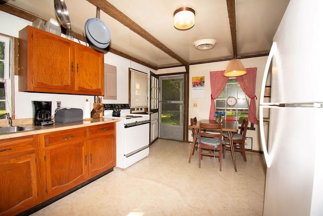 1026 Hoecake Rd, Lancaster, VA 22503 - kitchen featuring white appliances, brown cabinetry, healthy amount of natural light, light flooring, and beam ceiling