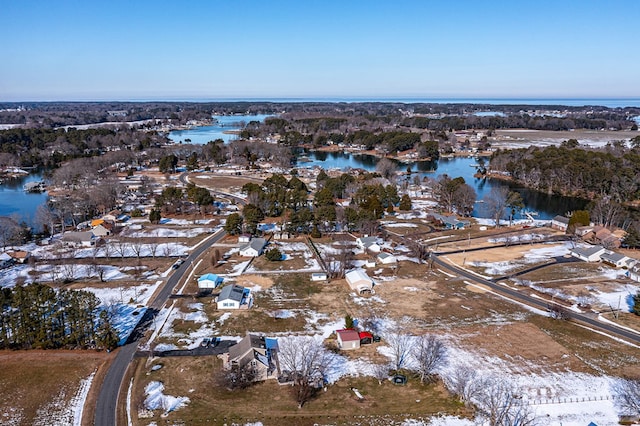 snowy aerial view with a water view