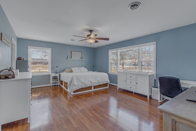 bedroom with ceiling fan and hardwood / wood-style floors