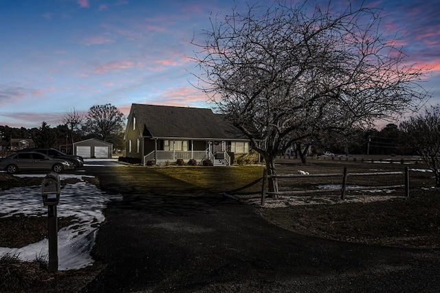 view of front of house featuring an outbuilding, a garage, and covered porch