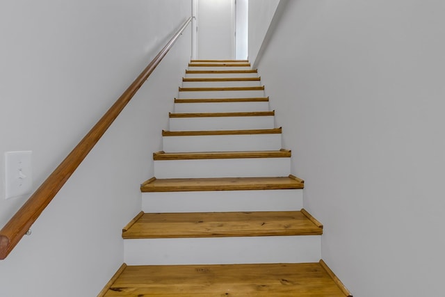 stairs with wood-type flooring