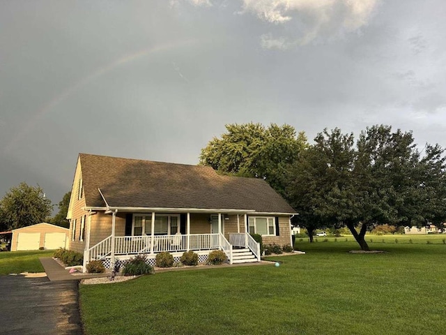 view of front of property with covered porch and a front lawn