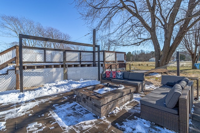 snow covered deck featuring an outdoor fire pit