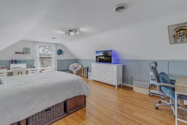 bedroom featuring light hardwood / wood-style floors and lofted ceiling