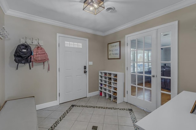 entrance foyer with light tile patterned flooring, ornamental molding, and french doors