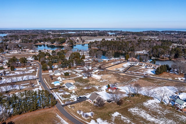 snowy aerial view with a water view