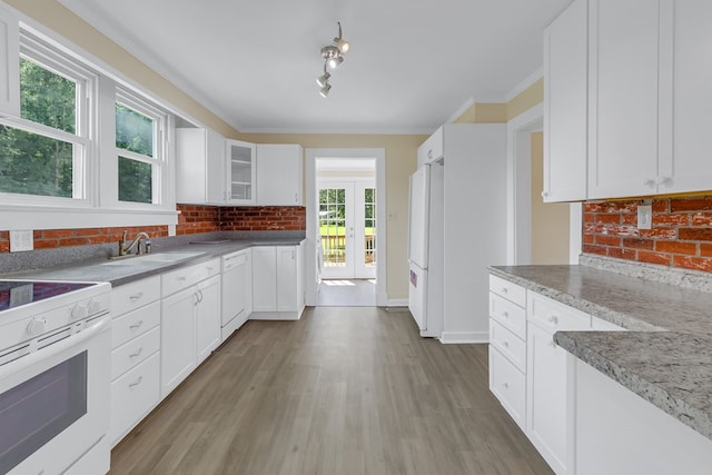 19 Wharton Grove Ln, Weems, VA 22576 - kitchen featuring decorative backsplash, white appliances, white cabinetry, and light wood-type flooring