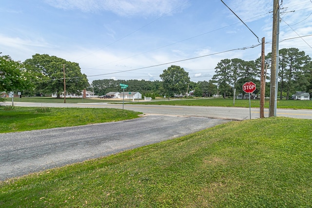 19 Wharton Grove Ln, Weems, VA 22576 - view of asphalt road featuring traffic signs