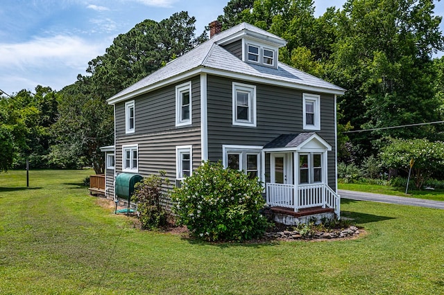 19 Wharton Grove Ln, Weems, VA 22576 - view of front facade featuring a chimney, a front yard, and oil tank