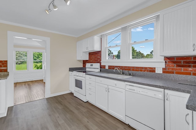 19 Wharton Grove Ln, Weems, VA 22576 - kitchen featuring white appliances, dark countertops, healthy amount of natural light, dark wood-style flooring, and crown molding