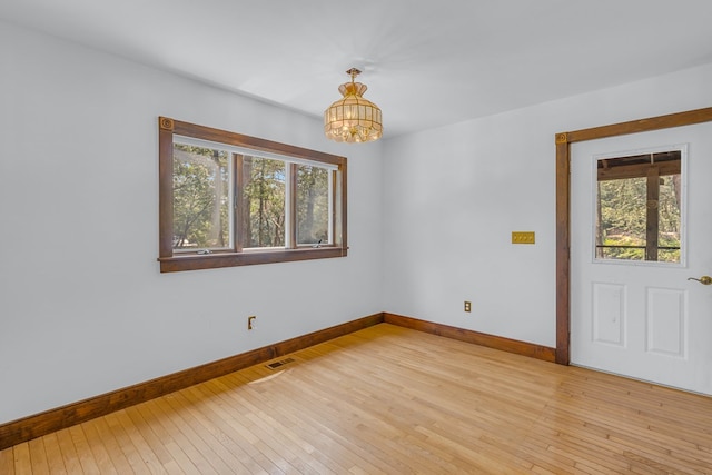 912 Levelgreen Rd, Lancaster, VA 22503 - spare room with a chandelier and light wood-type flooring