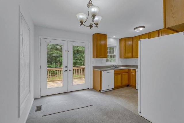 1 Bull Creek Dr, Lancaster, VA 22503 - kitchen featuring white appliances, french doors, light carpet, a chandelier, and a sink