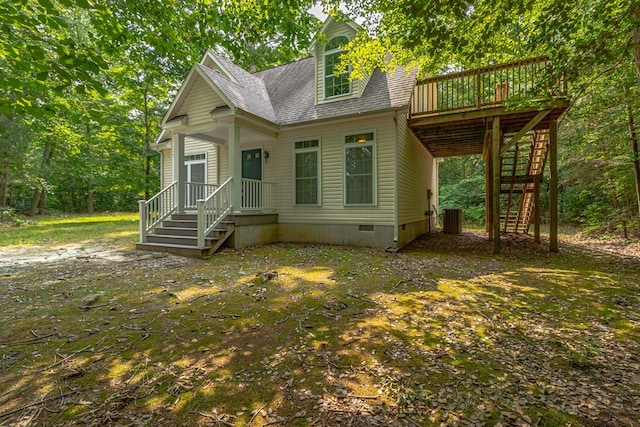 1 Bull Creek Dr, Lancaster, VA 22503 - view of front facade with stairs, crawl space, a shingled roof, a wooden deck, and central AC