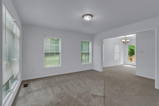 1 Bull Creek Dr, Lancaster, VA 22503 - carpeted spare room with a chandelier, baseboards, and plenty of natural light