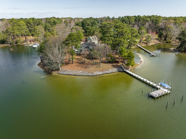 drone / aerial view featuring a water view and a view of trees