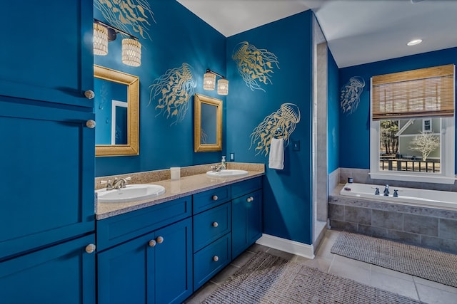 bathroom with tile patterned flooring, a sink, baseboards, a bath, and double vanity