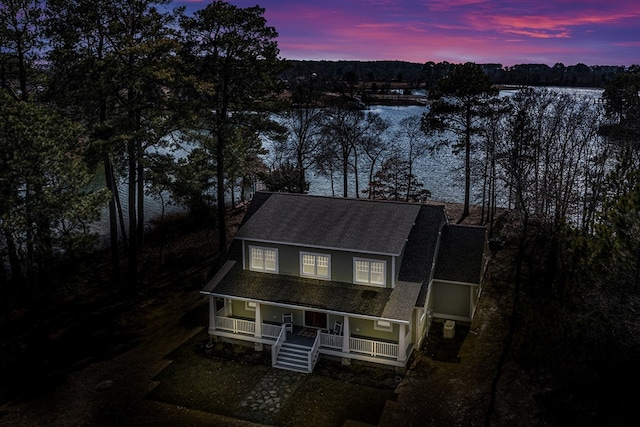 view of front of property with covered porch and roof with shingles