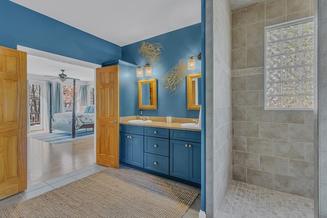 bathroom featuring connected bathroom, tile patterned flooring, a sink, and double vanity