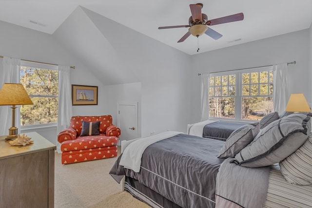 carpeted bedroom featuring lofted ceiling, multiple windows, and visible vents