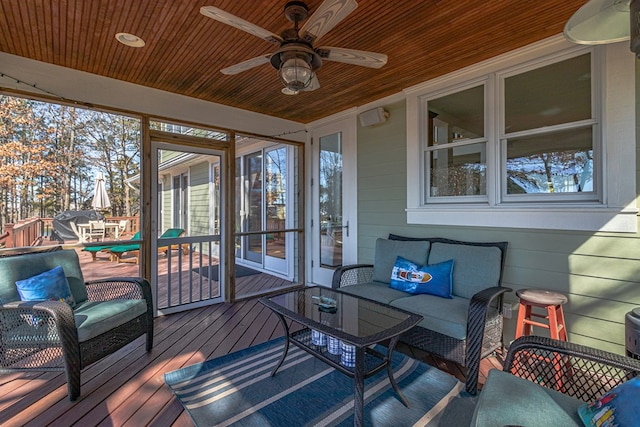 sunroom with a healthy amount of sunlight, wooden ceiling, and a ceiling fan