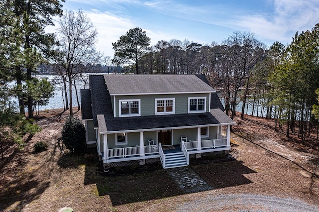 view of front of house with a shingled roof and covered porch