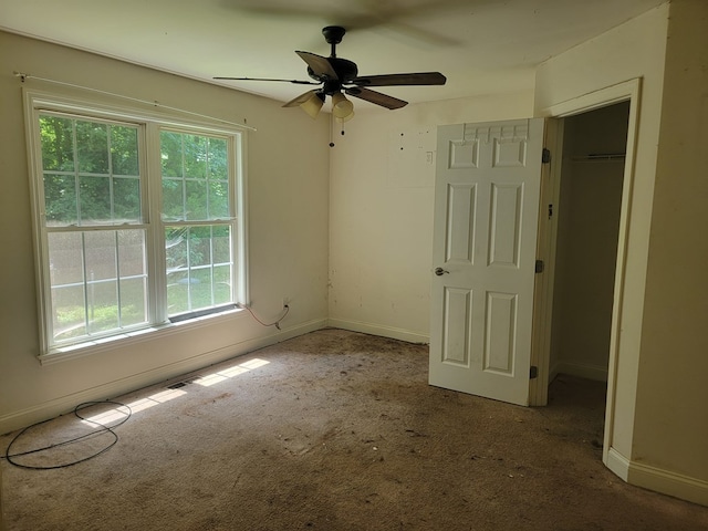 31 Moccasin Trl, Weems, VA 22576 - unfurnished bedroom with multiple windows, carpet flooring, and a closet
