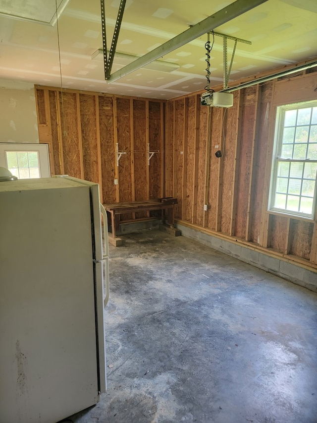 31 Moccasin Trl, Weems, VA 22576 - miscellaneous room with a garage, concrete floors, and attic access