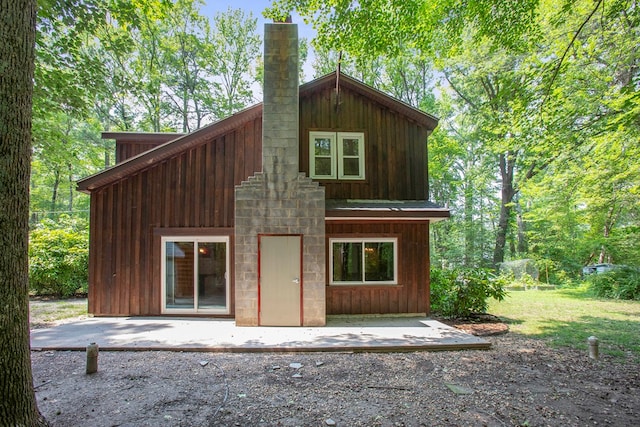 63 Pioneer Trl, Hague, VA 22469 - rear view of property featuring a chimney and a patio
