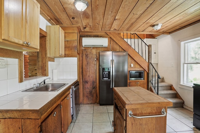 63 Pioneer Trl, Hague, VA 22469 - kitchen featuring appliances with stainless steel finishes, tile counters, wooden ceiling, light tile patterned floors, and an AC wall unit