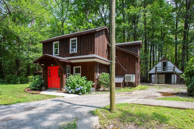 63 Pioneer Trl, Hague, VA 22469 - view of front of house featuring an outbuilding and a front lawn